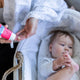 A baby and her mom using a Lanolin Nipple Balm