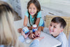 Kids probiotics gummies fiber gummies being offered by a mom to her children