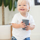 Sip Sip Hooray Happy Sippy Cup by Bella Tunno being held by a boy kid
