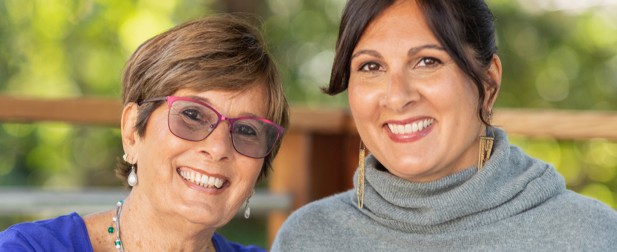 A mom wearing an eyeglass and a daughter smiling
