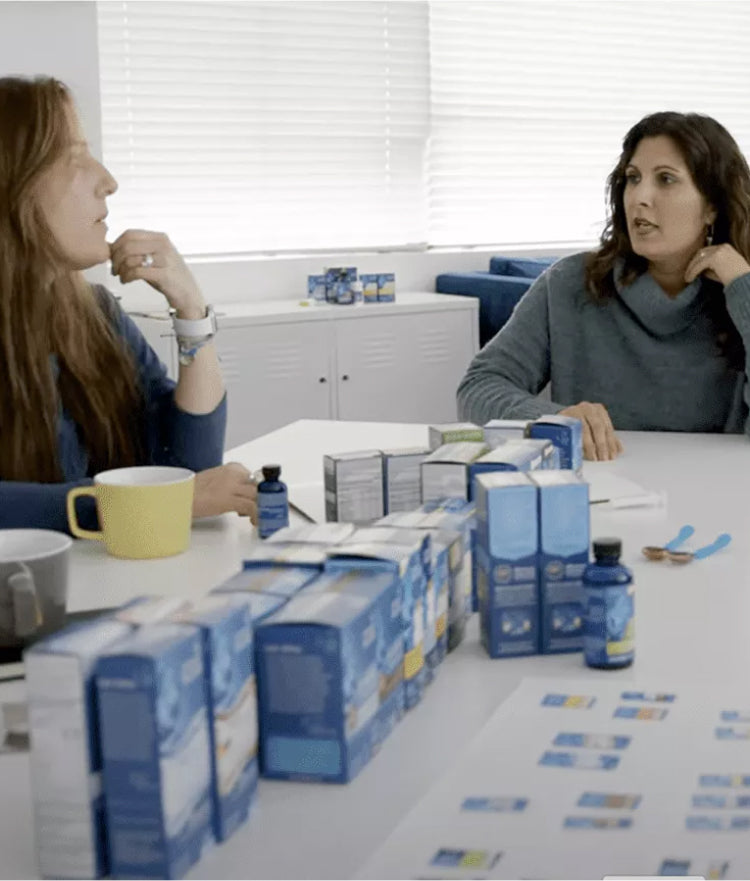 Three women discussing around the table with MB products on top of the table