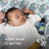 A baby sleeping with a gripe water product on the side with a syringe